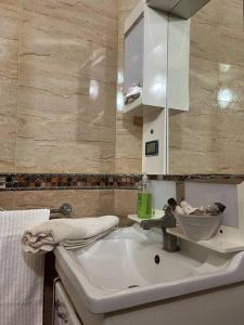 a bathroom sink with a faucet on top of it at Luxury suite in Ben Slimane