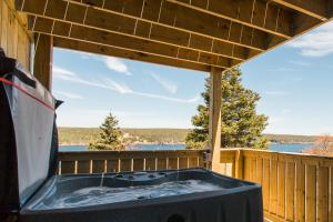 a hot tub on the deck of a house at Whale House Guest House in Mobile