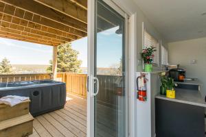 a bathroom with a hot tub on a deck at Whale House Guest House in Mobile