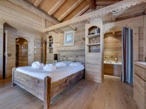 a bedroom with a large bed in a room with wooden walls at Chalet Montvalezan-La Rosière, 7 pièces, 14 personnes - FR-1-690-22 in Montvalezan