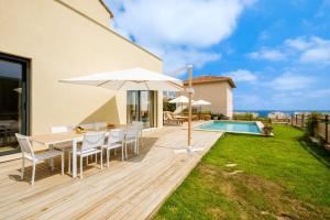 a wooden deck with a table and an umbrella at Sublime villa - centre Nice 8P in Nice