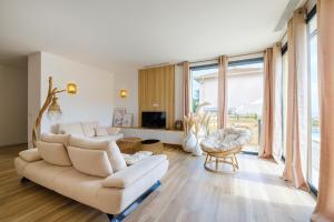 a living room with a couch and chairs and windows at Sublime villa - centre Nice 8P in Nice