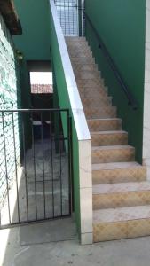 a staircase in a building with a green wall at Beach House in Salinas da Margarida