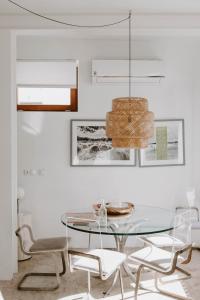 a dining room with a glass table and chairs at Melides Loft Teatro in Melides