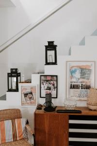 a living room with a table and pictures on the wall at Melides Loft Teatro in Melides