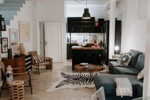 a living room with a couch and a kitchen at Melides Loft Teatro in Melides