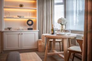 a dining room with a table with a bottle of wine at Blu's Seaview Apartment in Llandrillo-yn-Rhôs