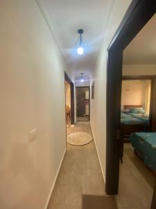 a hallway with a room with a bed and a ceiling at Luxurious, fully furnished and well equipped apartment with modern amenities, stunning views, and convenient location for remote work or studying from home in Madinaty