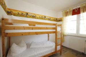 a bedroom with two bunk beds in a room at Strandschloesschen-Haus-II-WE-17-9871 in Kühlungsborn