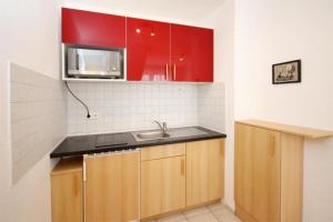 a kitchen with a sink and a microwave at Strandschloesschen-Haus-II-WE-23-9743 in Kühlungsborn