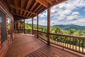 a porch of a cabin with a view of the mountains at Majestic mountaintop cabin, hot tub, fireplaces in Craytonia