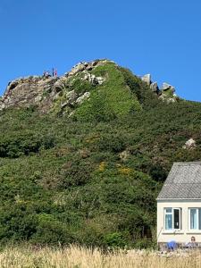 a house on the side of a hill at Pencaer Holiday Cottage in Goodwick