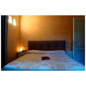 a bedroom with a bed with a book on it at Appartamento Virginia in Monti di Licciana Nardi