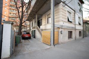 a car parked on a street next to a building at V & V Studio Apartments 2 in Niš