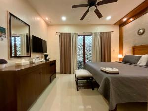 a bedroom with a bed and a dresser and a mirror at El Zaguán Colonial by GuruHotel in Valladolid