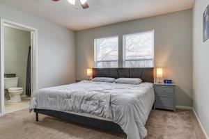 a bedroom with a large bed and a window at Indy Delight Charming House about 10 Mi to Downtown! in Indianapolis