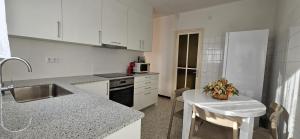 a kitchen with white cabinets and a counter top at CA LA LIDIA in Porqueres