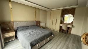 a bedroom with a large bed and a mirror at Fancy 3 bedroom Apartment super deluxe Furniture in Cimenli