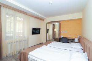 Postel nebo postele na pokoji v ubytování MANDARIN Hotel