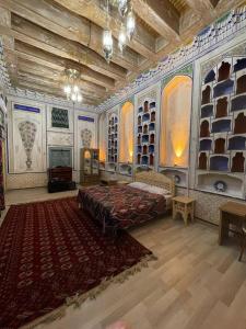 a large room with a bed and a rug at Bibi-Khanym Hotel in Bukhara