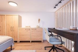 a bedroom with a desk and a bed and a chair at City Sky Loft in Vilnius in Vilnius