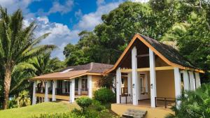 a small house in front of some trees at Top Ridge Views - 1 Bedroom in Sandy Bay