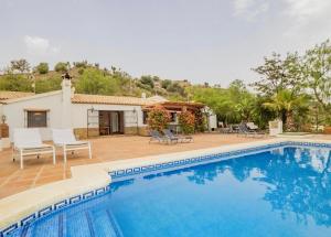 a swimming pool in front of a house at Villa Bellavista Malaga - Stunning Views - Private in Málaga