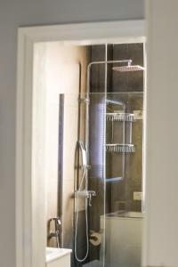 een badkamer met een douche en een glazen deur bij Viewpoint Central apartment in Tirana