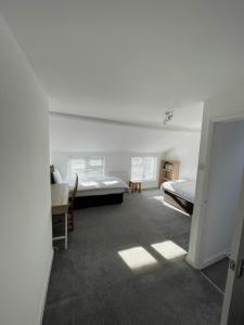 a bedroom with two beds and a table and chairs at Nunnery lane 3 bedroom house in York