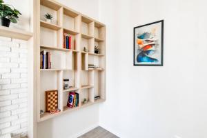 a book shelf on a wall with books at 1bdr Luxury Suit Prime Location Panorama Ac in Sofia