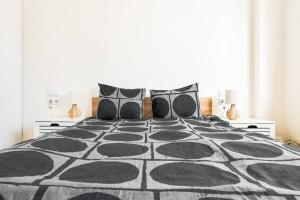 a bedroom with a black and white bed with pillows at Main Street Area Metro Washer&dryer View in Sofia