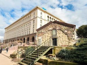 a large stone building with a staircase in front of it at Main Street Area Metro Washer&dryer View in Sofia