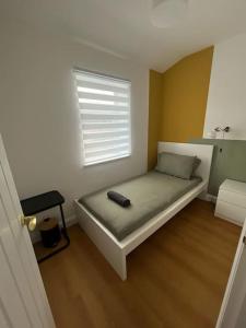 een slaapkamer met een bed met een afstandsbediening bij Impressive, Spacious Anfield Home, LFC & EFC in Liverpool