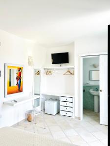 a white room with a desk and a tv at Balconcino d'Oriente in Otranto