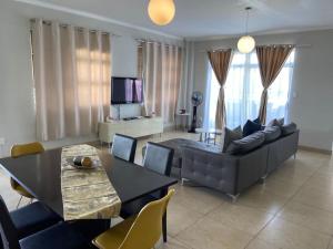 een woonkamer met een bank en een tafel bij Maerua Mall Luxe Accommodations 3rd Floor in Windhoek