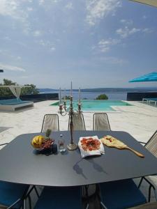 a table with a plate of food on it at Villa HB Crikvenica in Crikvenica