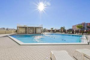 a large swimming pool with chairs and a building at Inlet Reef 616 Destin Condo in Destin