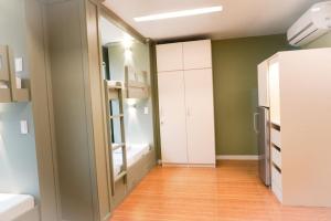 a small room with a bathroom with a mirror at ALTEAN Apartments - Lourdes Room in Manila
