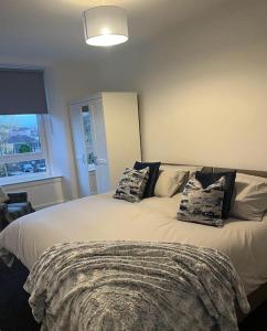 a bedroom with a bed with two pillows on it at Albert House in Airdrie