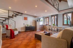 a living room with a couch and a table at Sa Domo Apartments in Alghero