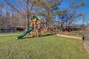 a playground with a slide in the grass at Riverfront Kresgeville Getaway Near Blue Mountain! 