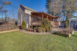 a house with a deck and a yard at Riverfront Kresgeville Getaway Near Blue Mountain! 