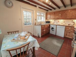 a kitchen with a table and a sink and a stove at Dale View in Whitby