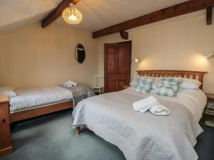 a bedroom with two beds with towels on them at Dale View in Whitby