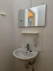 a bathroom with a sink and a mirror at Lait Hostel in Ioannina
