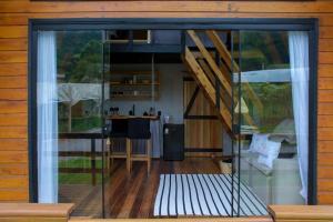 a room with a sliding glass door and a staircase at Refúgio do Vale Cabanas Exclusivas in Bento Gonçalves