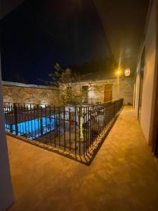 a fence in front of a pool at night at Choco Hostel in Puebla