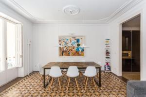 a dining room with a table and four chairs at Ronda Sant Pere in Barcelona