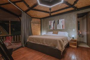 a bedroom with a large bed in a room at Shabbat Hotel Boutique in San Vicente