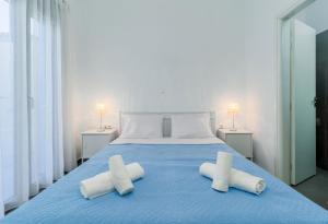 a bedroom with a blue bed with two white pillows at Ioannis House in Sellía +38 photos